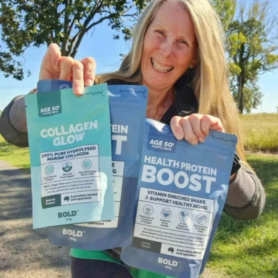 Woman holding two packages of 'Collagen Glow' and 'Health Protein Boost' products outdoors.